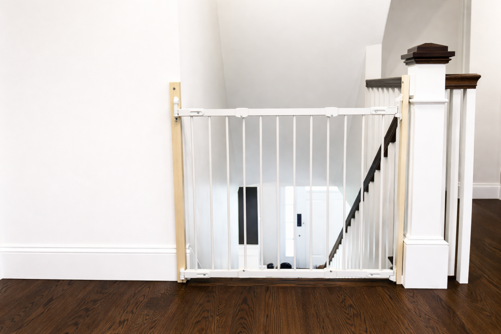 Child safety gate installed at the top of stairs to prevent falls in a Toronto home