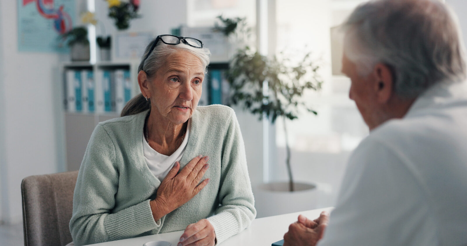 Older woman speaking with healthcare professional before hospital discharge