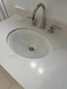 Clean bathroom sink after hair and drain cleaning showing clear drainage