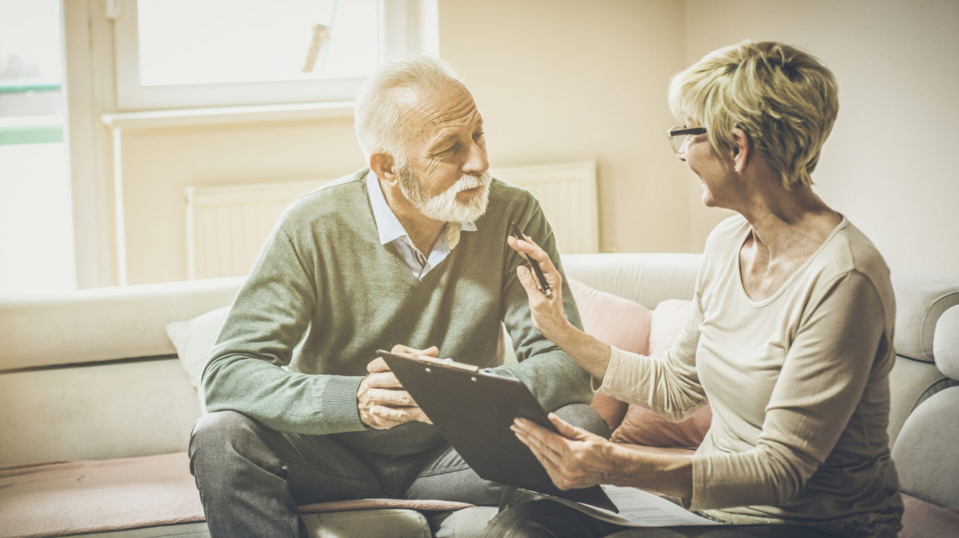 Older couple reviewing home safety recommendations after an in-home consultation
