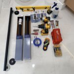 Tools and hardware used for grab bar installation in Toronto including anchors, drill bits, and mounting equipment