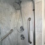Grab bar installation in Toronto shower with vertical and horizontal safety bars on tile wall