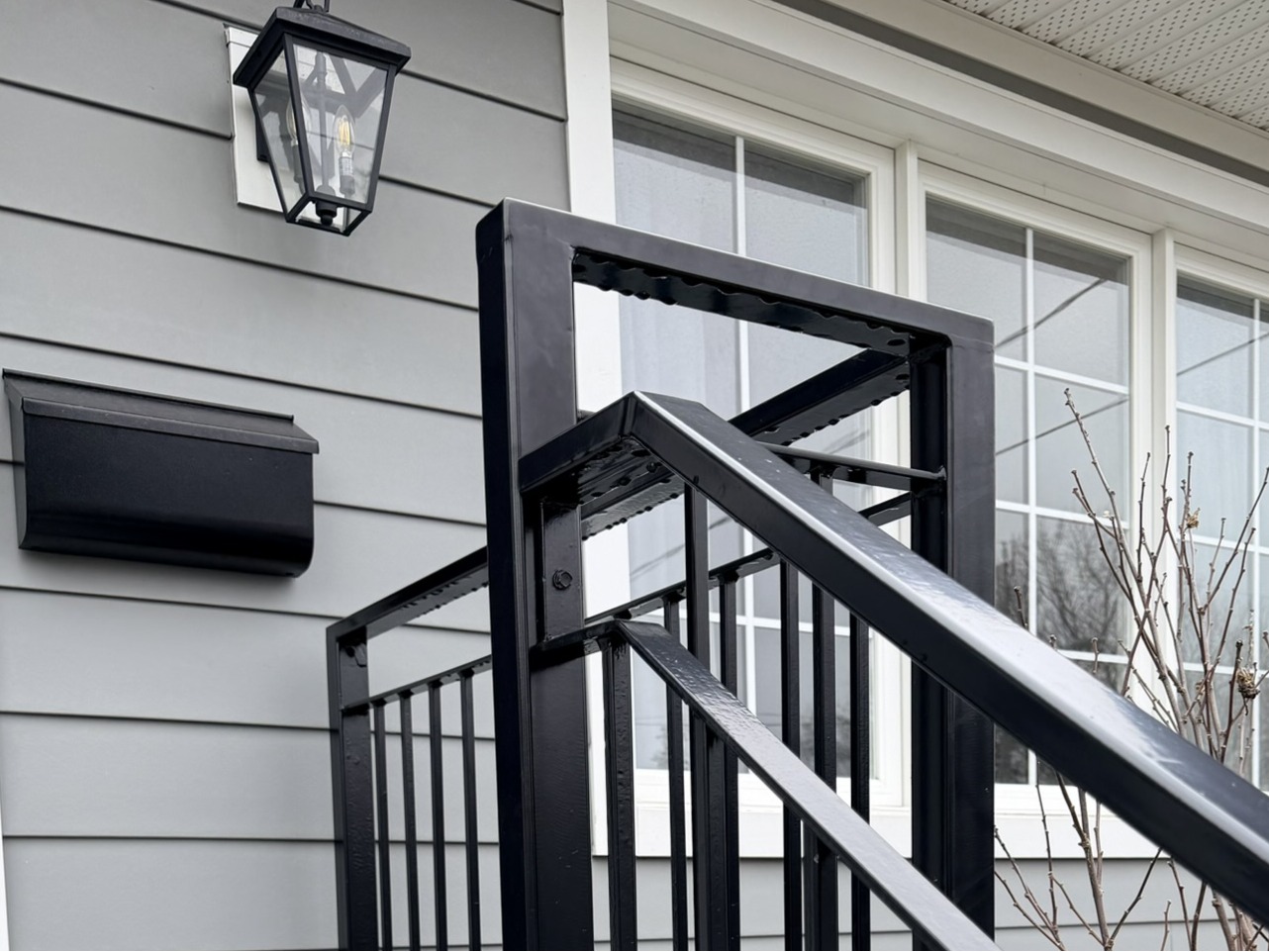Exterior stair railing installation on front steps of a residential home in Toronto
