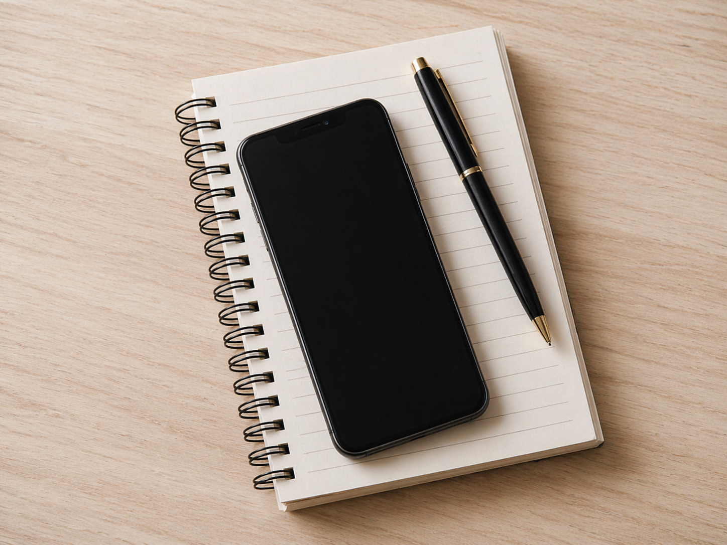 Workspace with phone and notebook representing easy communication and scheduling with Good Company home safety and accessibility services in Toronto, Vaughan, Richmond Hill, and Etobicoke. Contact Good Company today.
