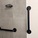 Matte black grab bars installed in a modern walk-in shower for bathroom safety and accessibility in Toronto