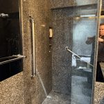 Custom granite walk-in shower with professionally installed grab bars for bathroom safety and accessibility in Toronto