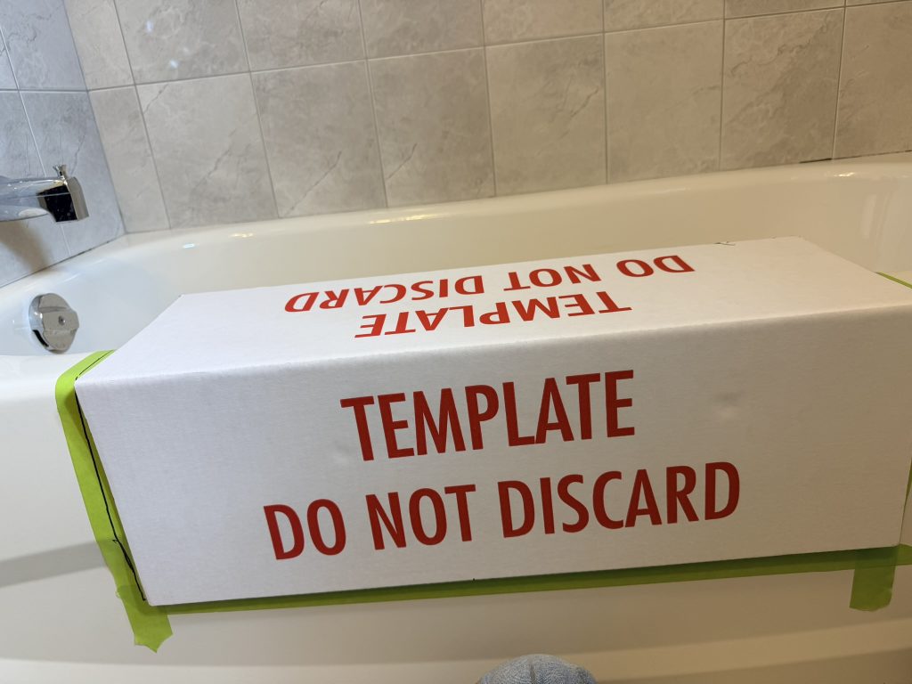 Template used to mark a bathtub cutout before cutting a steel bathtub in Toronto