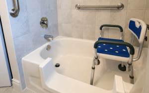 Accessible bathtub with a professionally installed bathtub cutout, grab bars and transfer bench in a Toronto home.